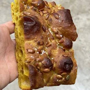 a hand holding a piece of bread