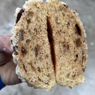 a person holding a piece of bread