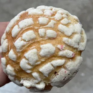 a hand holding a pastry