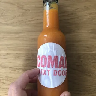 BOTTLE OF HOUSEMADE HABANERO-CARROT HOT SAUCE