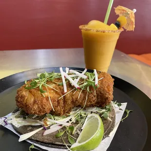 Crispy (GF) Cod on a Blue Corn Tortilla with Slaw, Creamy Chipotle and Microgreen Cilantro.