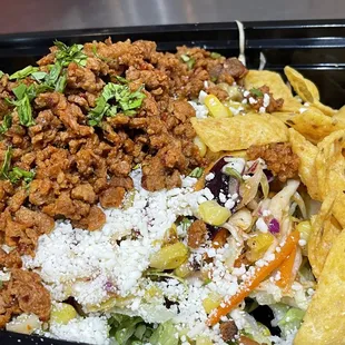 Comal Meatless Bowl with Rice, Black Beans, Roasted Corn, Slaw &amp; Fritos.