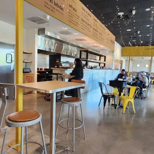 Nicely done dining area with view of taco chefs making the