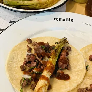 Tacos asados de sirloin with roasted onions.