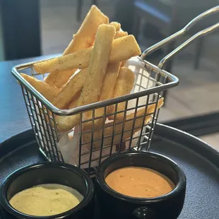 Yucca fries with amazing dipping sauces! A must have.