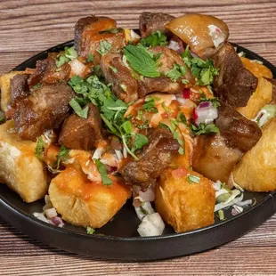 Yuca Frita 

Yuca and chicharron, served with cabbage, tomatoes and salsa