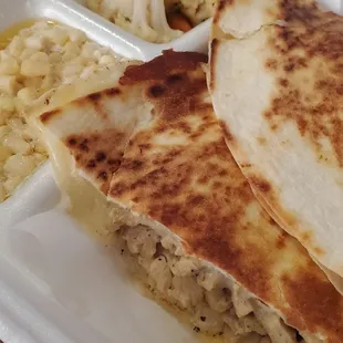 two quesadillas in a styrofoam container