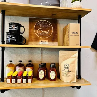 a shelf of coffee and honeys