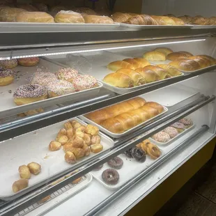 a variety of donuts in a display case
