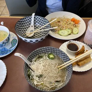 Egg drop soup, pho, Cambodian style fried rice, pork dumplings, fried spring rolls, and red bean boba smoothie.