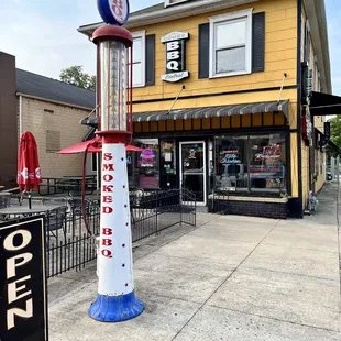 a gas pump in front of a restaurant