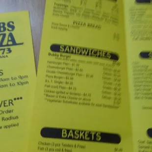 a hand holding a menu