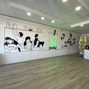 a cafe with a mural on the wall