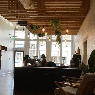 people sitting at a counter in a coffee shop