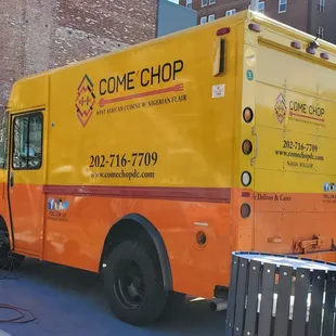 a yellow food truck parked on the side of the road
