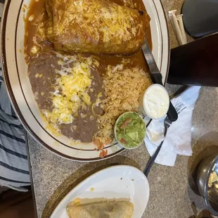 a plate of enchiladas and a bowl of salsa