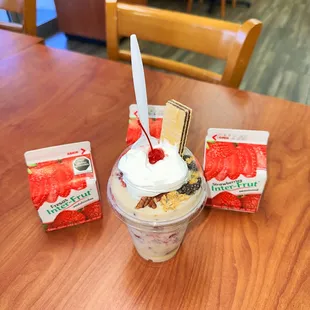 a cup of ice cream with strawberries and strawberries