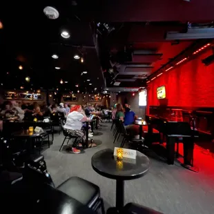 people sitting at tables in a dimly lit room