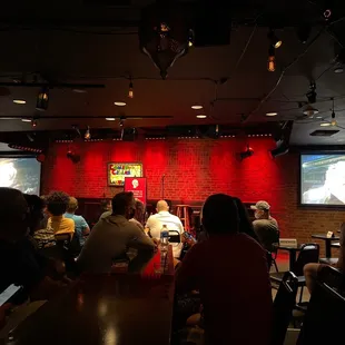 a group of people sitting at a bar