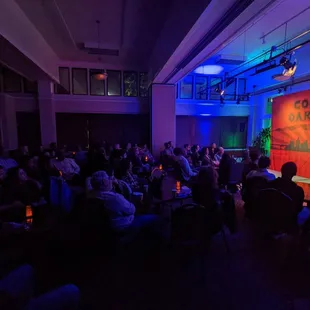 a man standing on a stage in front of a crowd