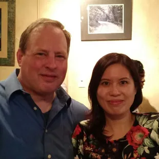 At a larger table at the comedy club.