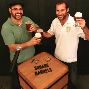 two men toasting with beer