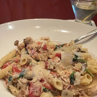 a plate of pasta with meat and vegetables