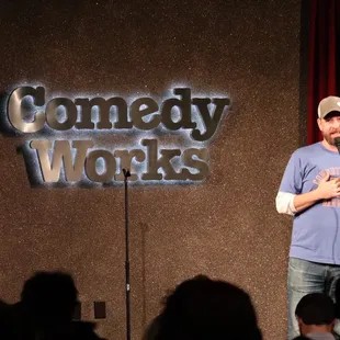 a man on stage speaking into a microphone