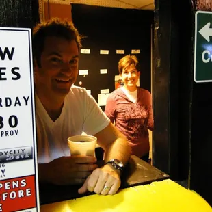a man sitting at a bar with a cup of coffee