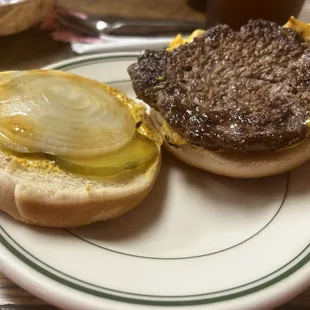 a burger and a pickle on a plate