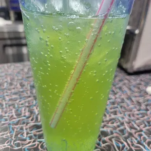 a green drink with a straw