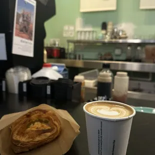 Latte and savory cheese and spinach pastry