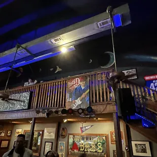 a man on a balcony playing a guitar