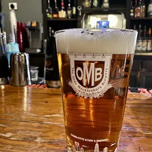 a pint of beer on a bar