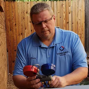 Me adjusting a refrigerant charge on an install