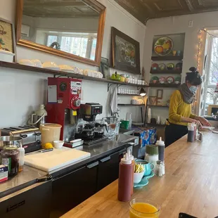 a kitchen with a counter and a person in the background