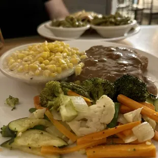 Meatloaf with corn and roasted vegetables.