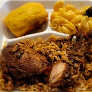 Dominican style brown stew chicken over rice with mac and cheese and cornbread