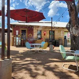 tables and chairs under umbrellas