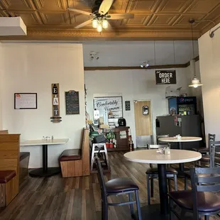 a dining area with tables and chairs