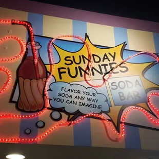 a neon sign for a soda bar