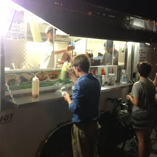 people ordering food from a food truck