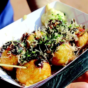 a person holding a box of food