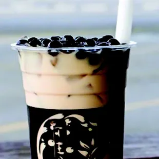 a cup of iced coffee with blueberries
