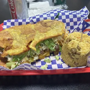 The famous Jibarito sandwich and arroz con gandules (yellow rice with pigeon peas).