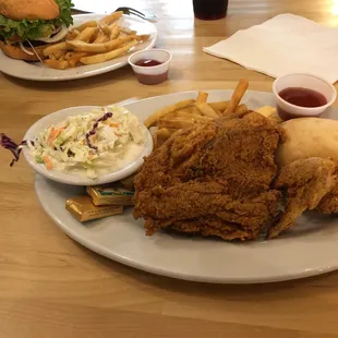a plate of fried chicken, fries, coleslaw and coleslaw