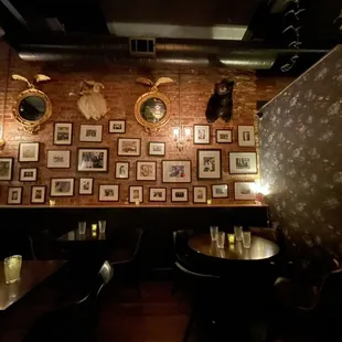 a brick wall with a lot of pictures on it