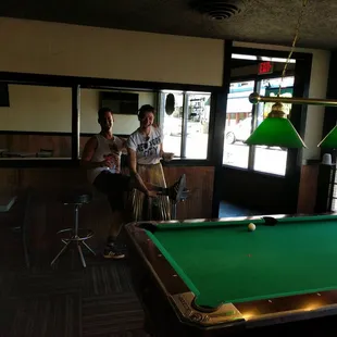 a man and a woman playing pool