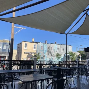 a patio with tables and chairs
