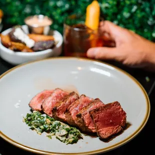 a hand holding a plate of food